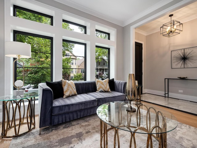 living room featuring crown molding, wood-type flooring, and an inviting chandelier