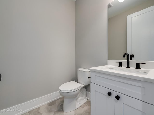 bathroom with vanity, tile patterned flooring, and toilet