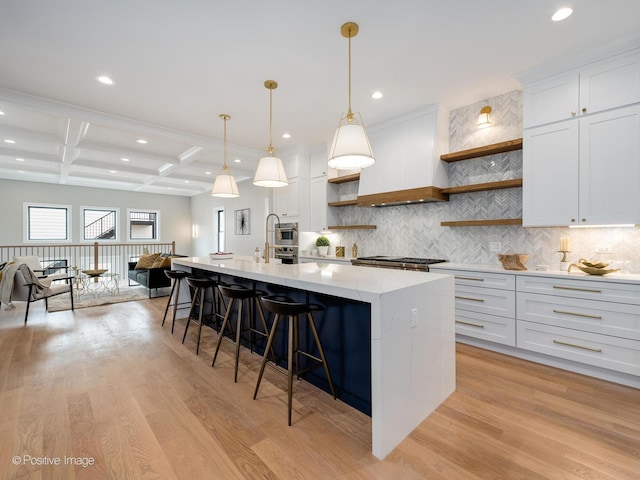 kitchen featuring white cabinetry, coffered ceiling, beam ceiling, and pendant lighting