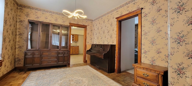 misc room with parquet floors and an inviting chandelier