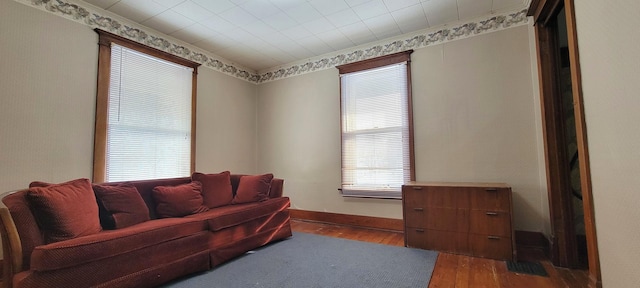 sitting room featuring ornamental molding and dark hardwood / wood-style flooring