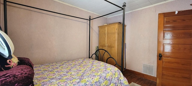 bedroom with hardwood / wood-style flooring and ornamental molding