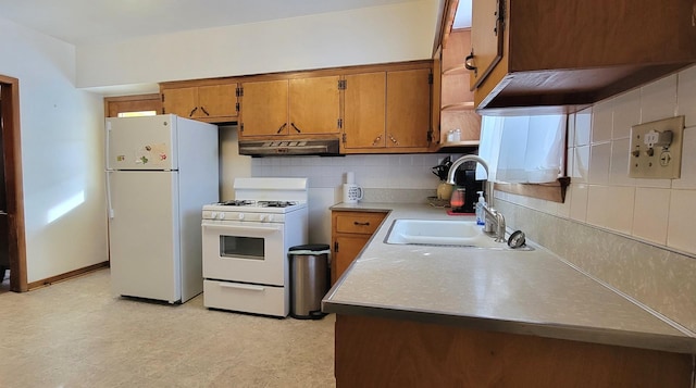 kitchen featuring tasteful backsplash, sink, and white appliances