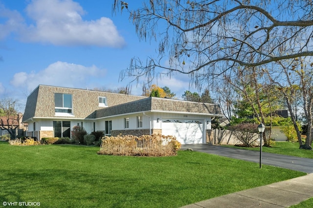 view of front of home featuring a garage and a front lawn