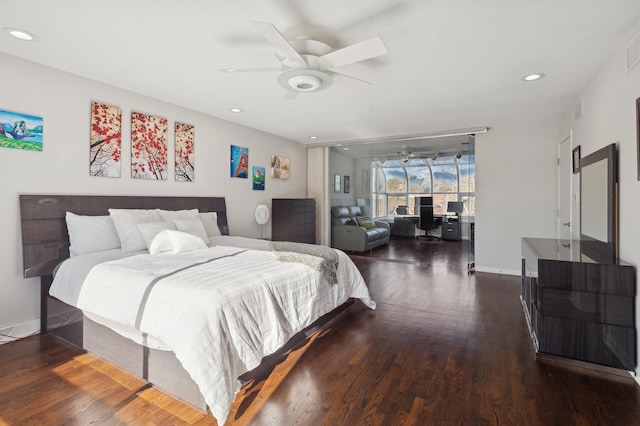 bedroom with dark hardwood / wood-style flooring and ceiling fan