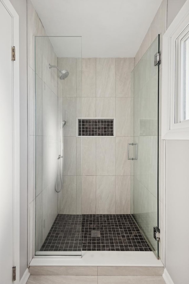 bathroom with a shower with door