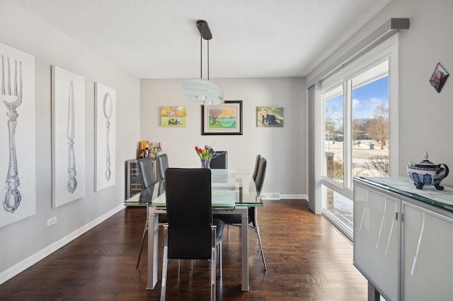 dining space featuring dark hardwood / wood-style floors and a textured ceiling