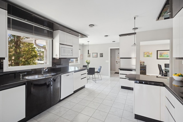 kitchen with pendant lighting, white cabinetry, white appliances, and sink