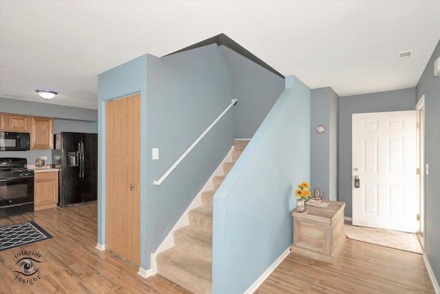 stairs featuring baseboards and wood finished floors