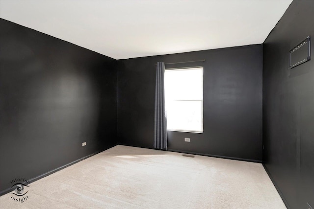 carpeted spare room with visible vents