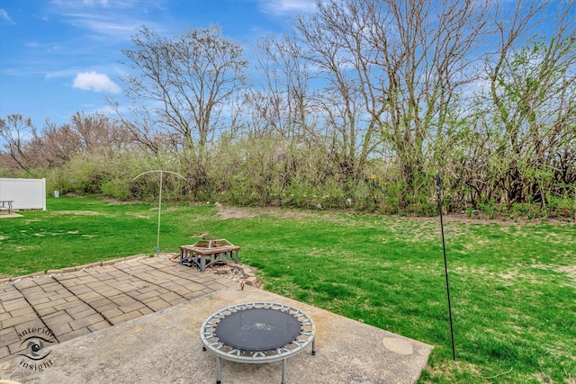 view of yard with a fire pit and a patio