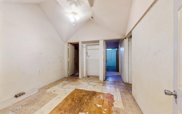 hall featuring lofted ceiling