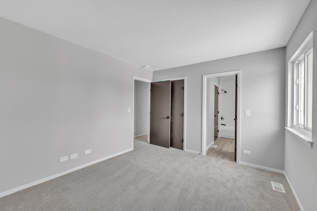 unfurnished bedroom featuring light colored carpet