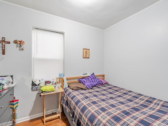 bedroom featuring hardwood / wood-style flooring and crown molding