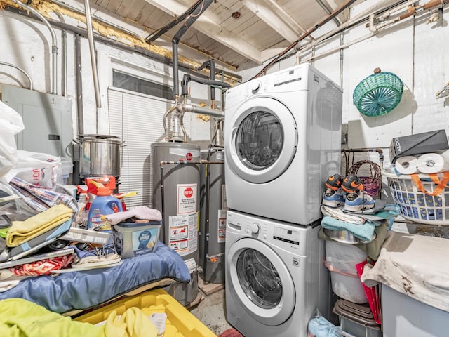 laundry area featuring gas water heater and stacked washer / dryer