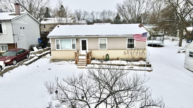 view of front of property featuring brick siding and a trampoline