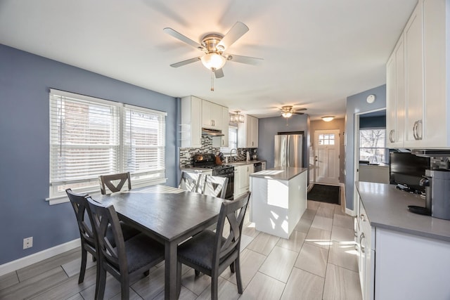 dining area with sink and ceiling fan