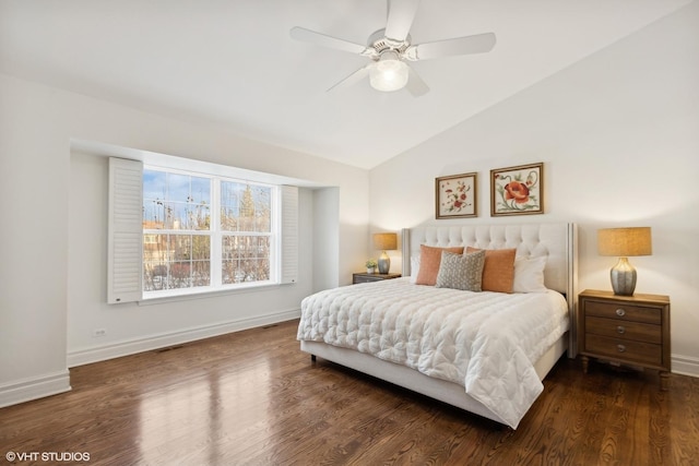 bedroom with ceiling fan, dark hardwood / wood-style floors, and vaulted ceiling