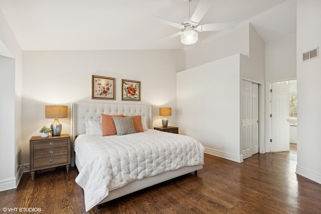 bedroom featuring ceiling fan, dark hardwood / wood-style flooring, high vaulted ceiling, and a closet