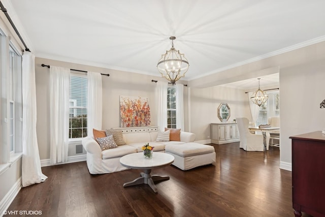 living room with ornamental molding, dark hardwood / wood-style floors, and a chandelier