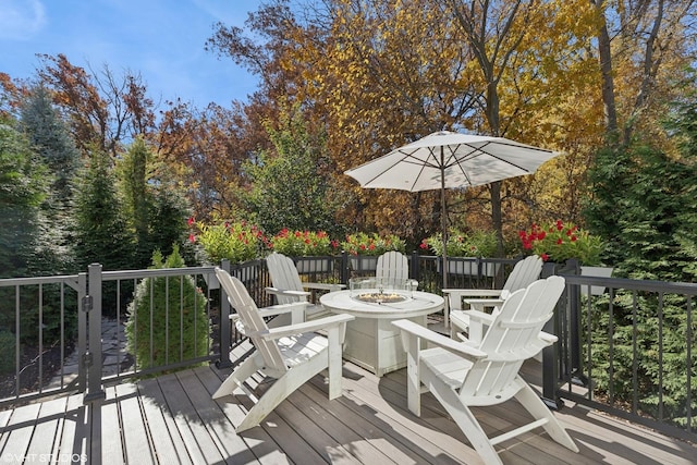 wooden deck with an outdoor fire pit