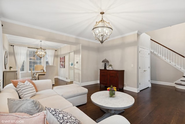 living room with a notable chandelier, dark wood-type flooring, and ornamental molding