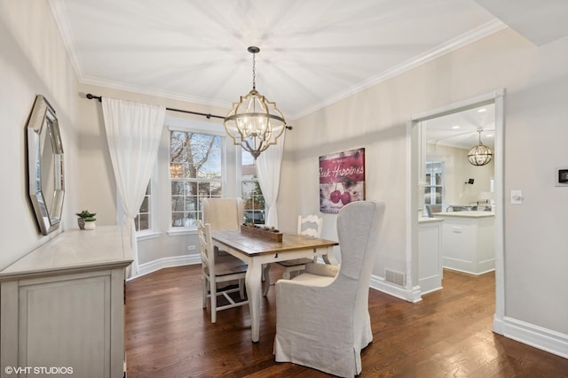 dining space featuring ornamental molding, dark wood-type flooring, and a notable chandelier