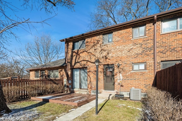 rear view of property with central AC and a deck