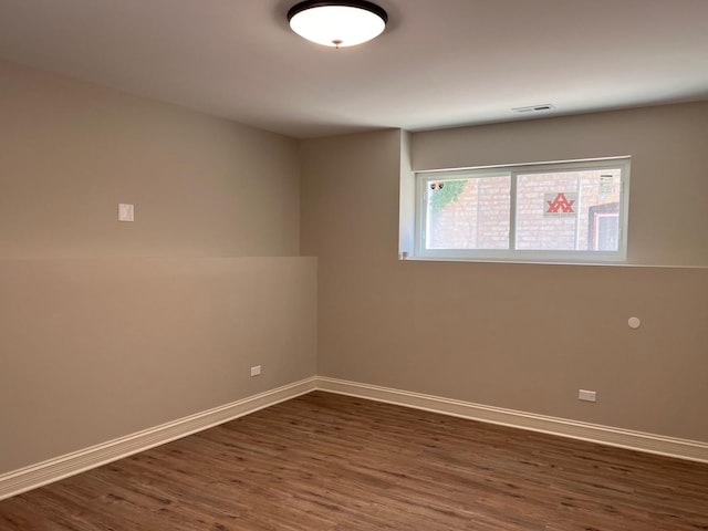 spare room featuring dark wood-type flooring