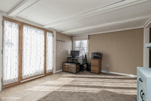 carpeted office space featuring beamed ceiling