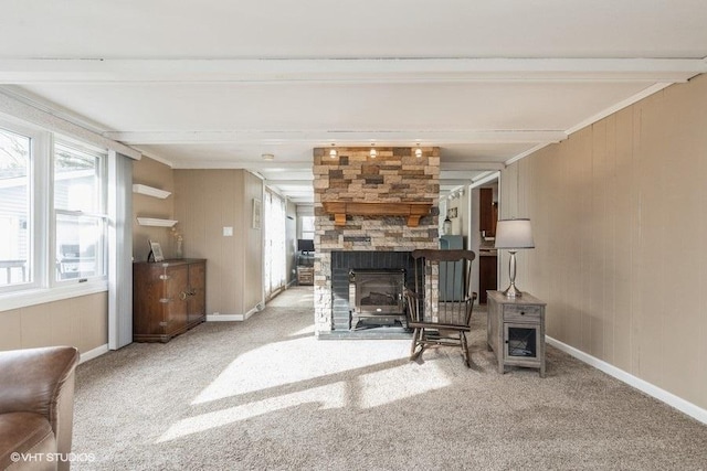 living room featuring light colored carpet, beam ceiling, and a fireplace