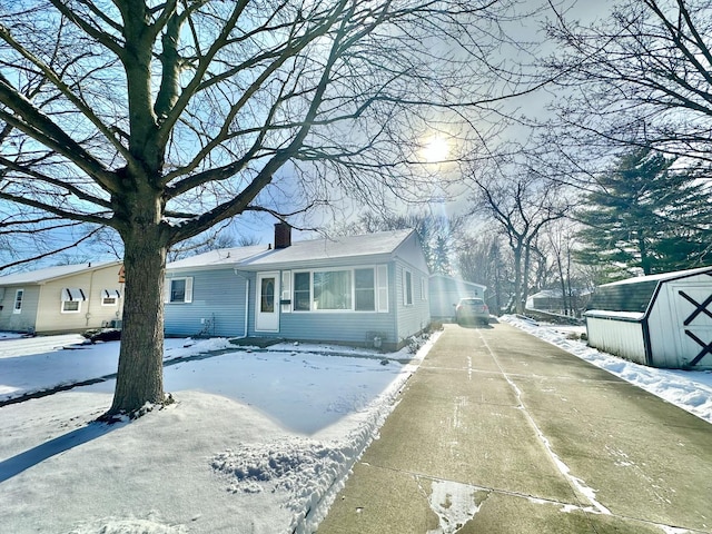 view of front of house with a storage unit