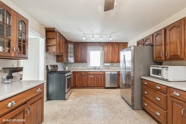 kitchen featuring stainless steel appliances, sink, and backsplash