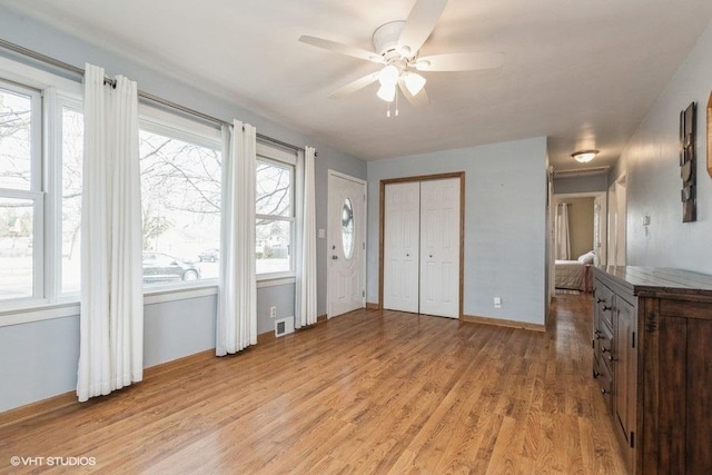 living room with ceiling fan and light hardwood / wood-style floors