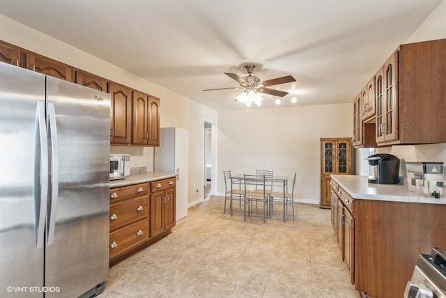 kitchen with ceiling fan, stainless steel fridge, and stove