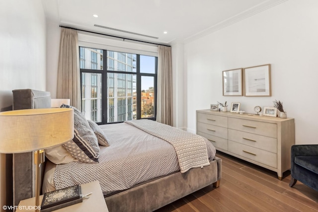 bedroom featuring recessed lighting, ornamental molding, and wood finished floors