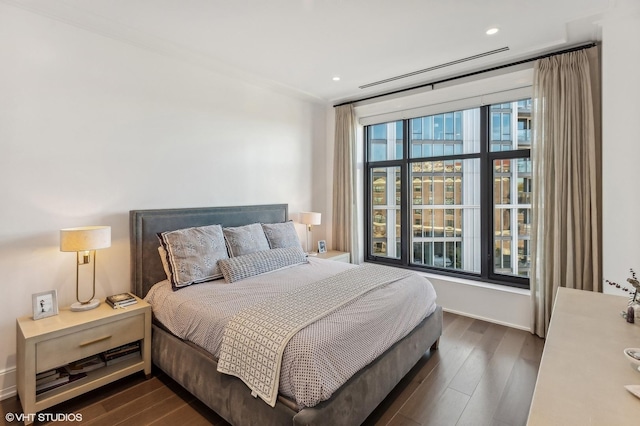 bedroom featuring recessed lighting, baseboards, and dark wood-style flooring