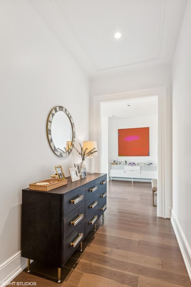 corridor with wood finished floors and baseboards