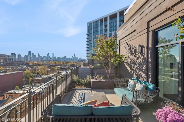 balcony featuring a city view and an outdoor living space