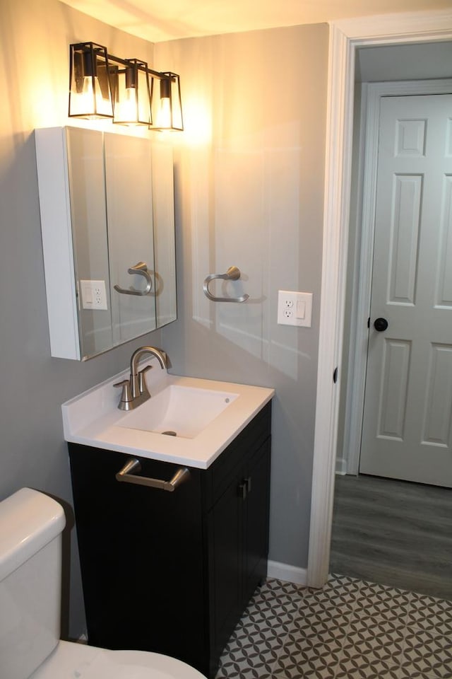 bathroom featuring vanity and toilet