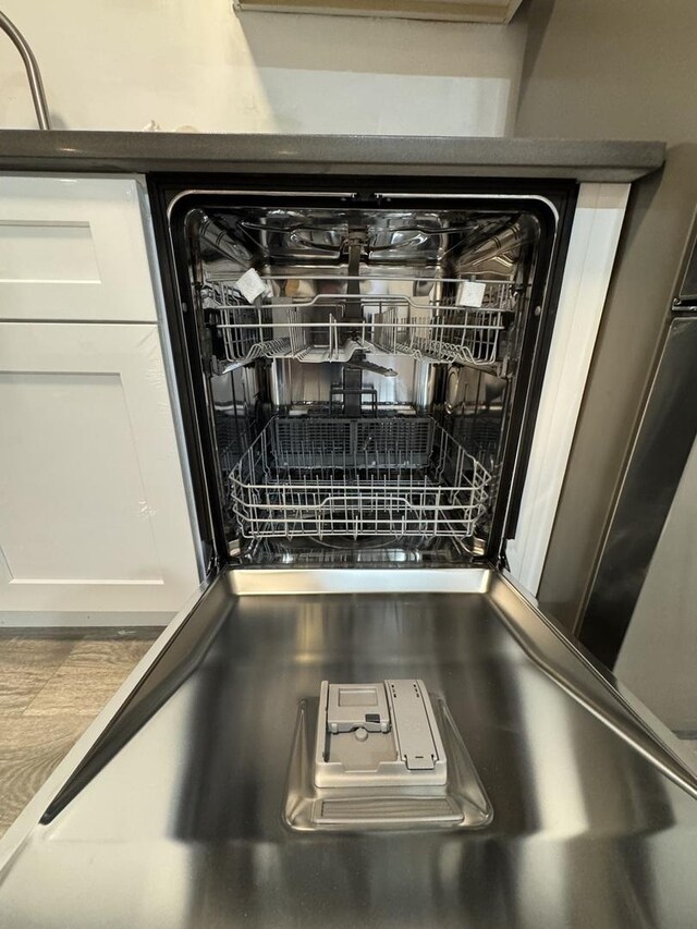 details with white cabinetry and dishwasher