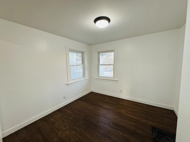 empty room with dark wood-type flooring