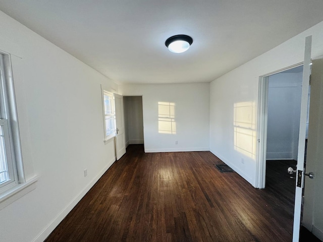 spare room with dark hardwood / wood-style flooring