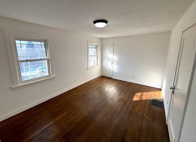 unfurnished room featuring dark hardwood / wood-style flooring