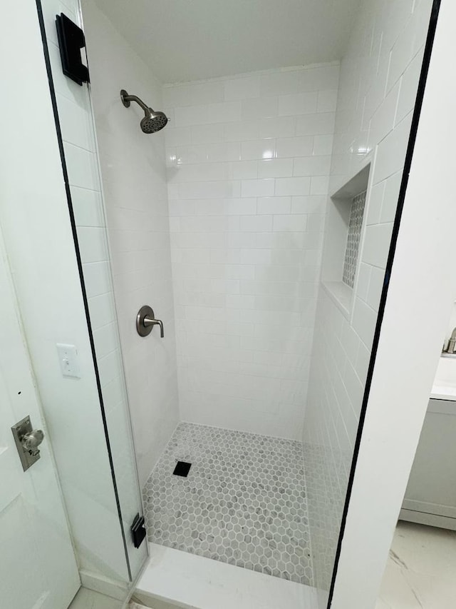 bathroom featuring a shower with shower door