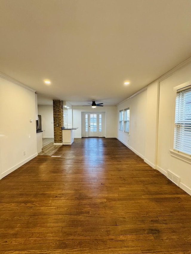 unfurnished living room featuring ornamental molding, dark hardwood / wood-style floors, and ceiling fan