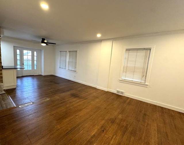 empty room with ceiling fan, ornamental molding, and dark hardwood / wood-style flooring