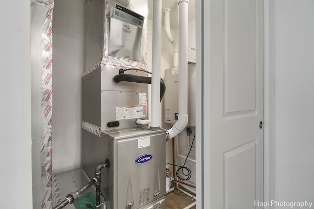 utility room featuring heating unit