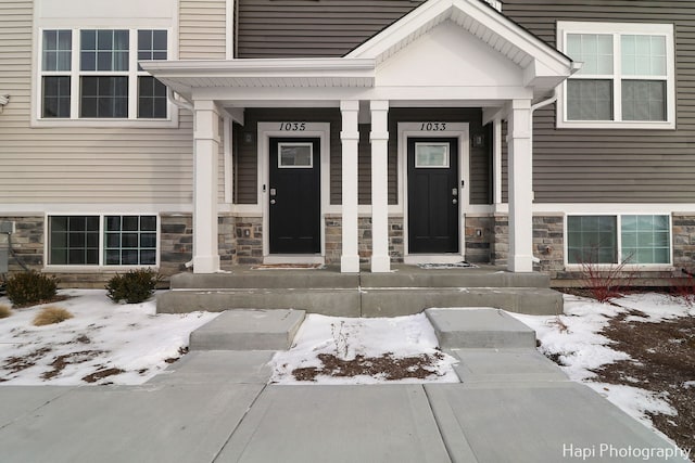 view of snow covered property entrance