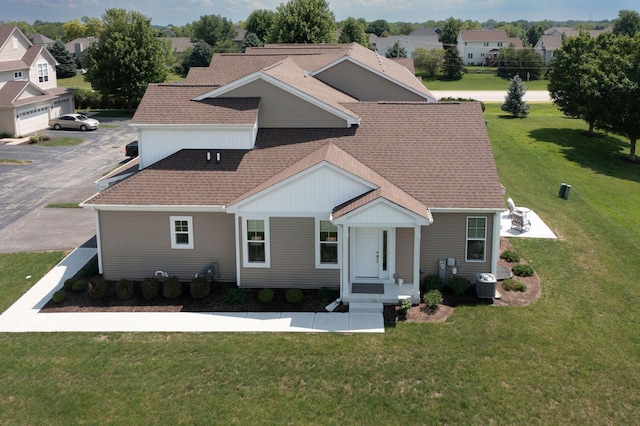 view of front of house featuring central AC and a front yard